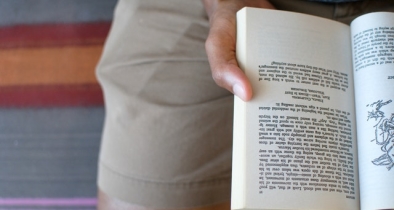 man reading book in lap