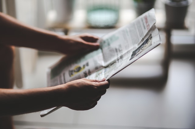 person holding a newspaper