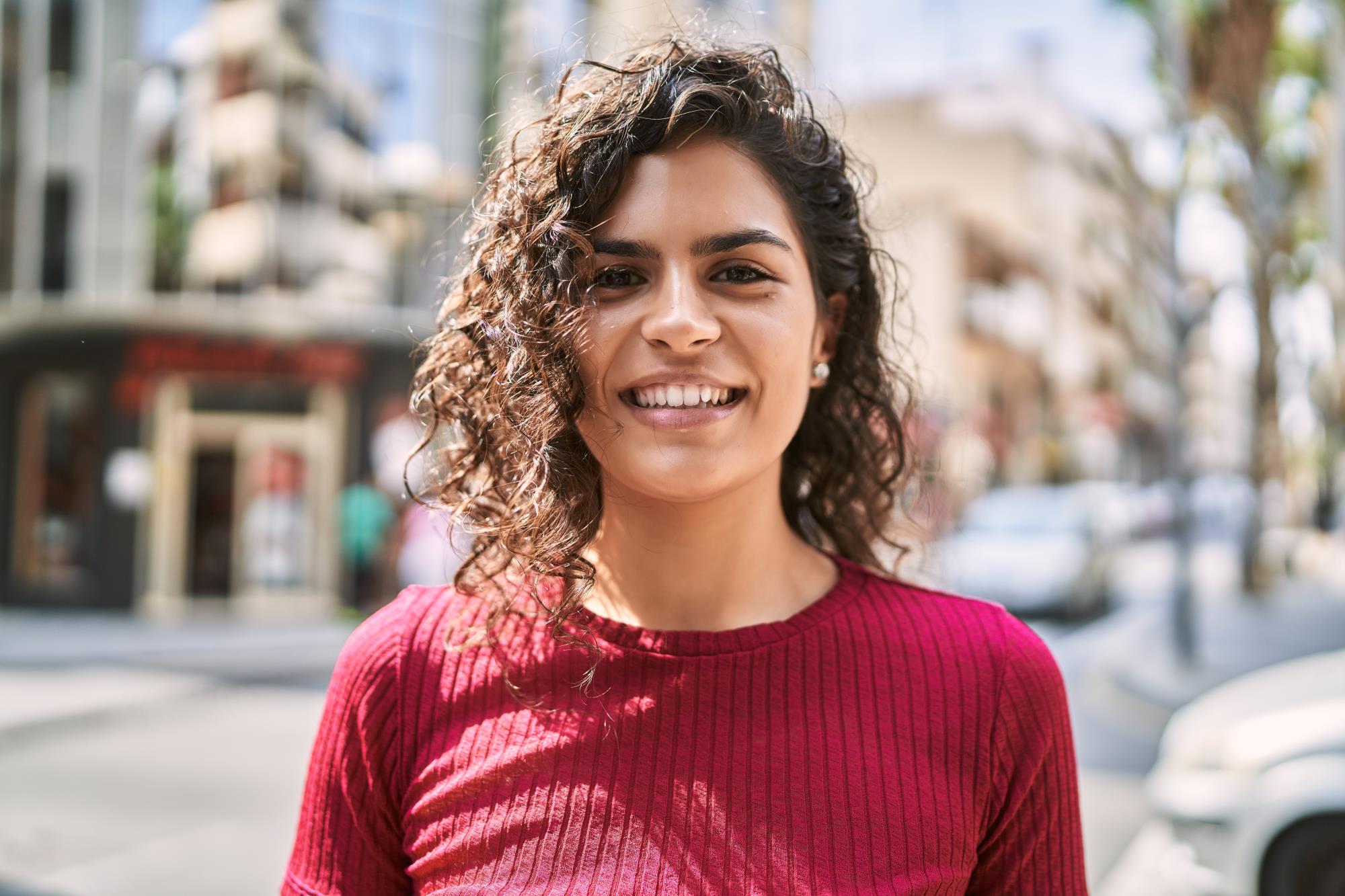 young-latin-woman-smiling-confident-standing-street