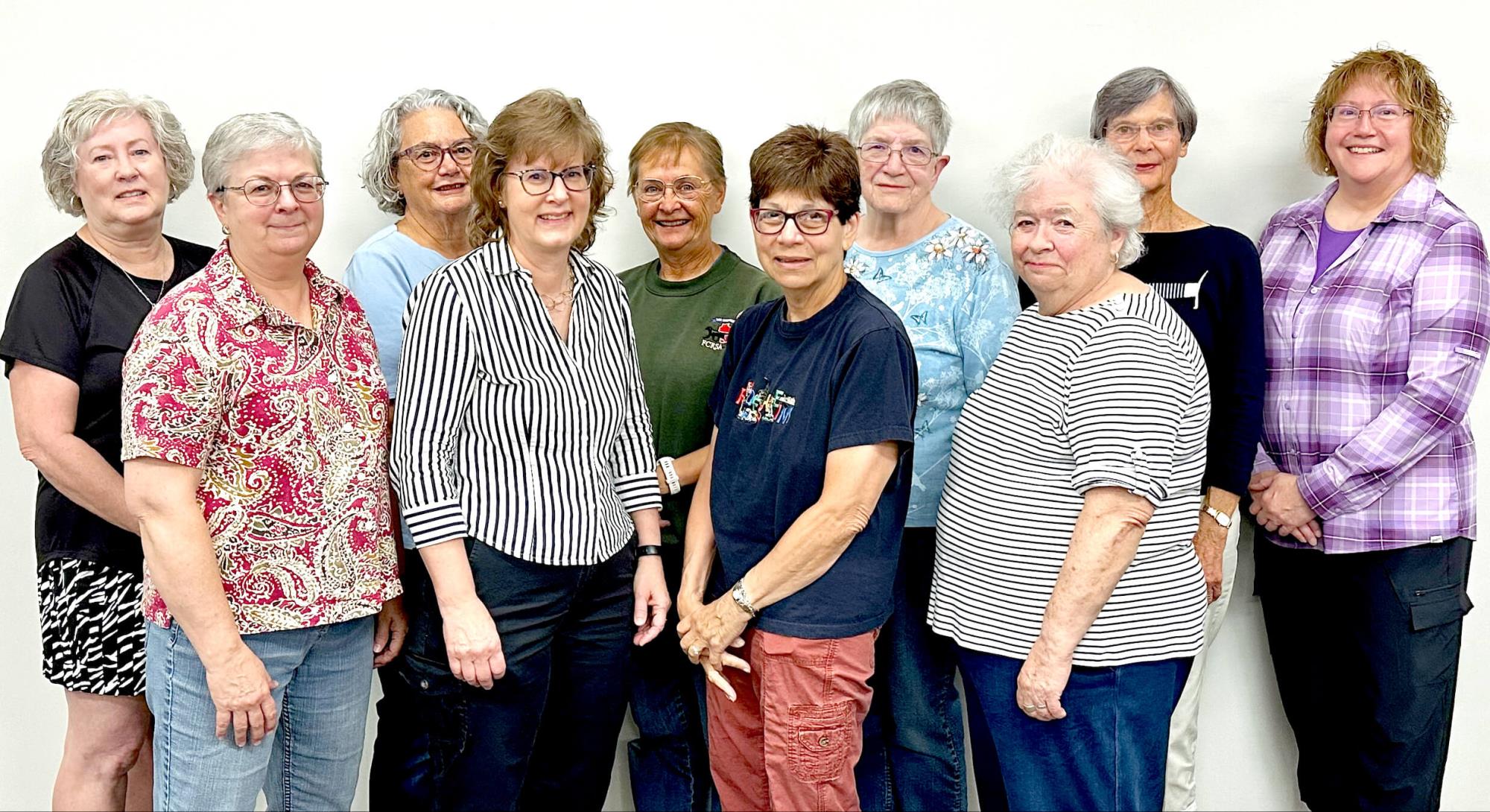 10 people posing for a photo while standing