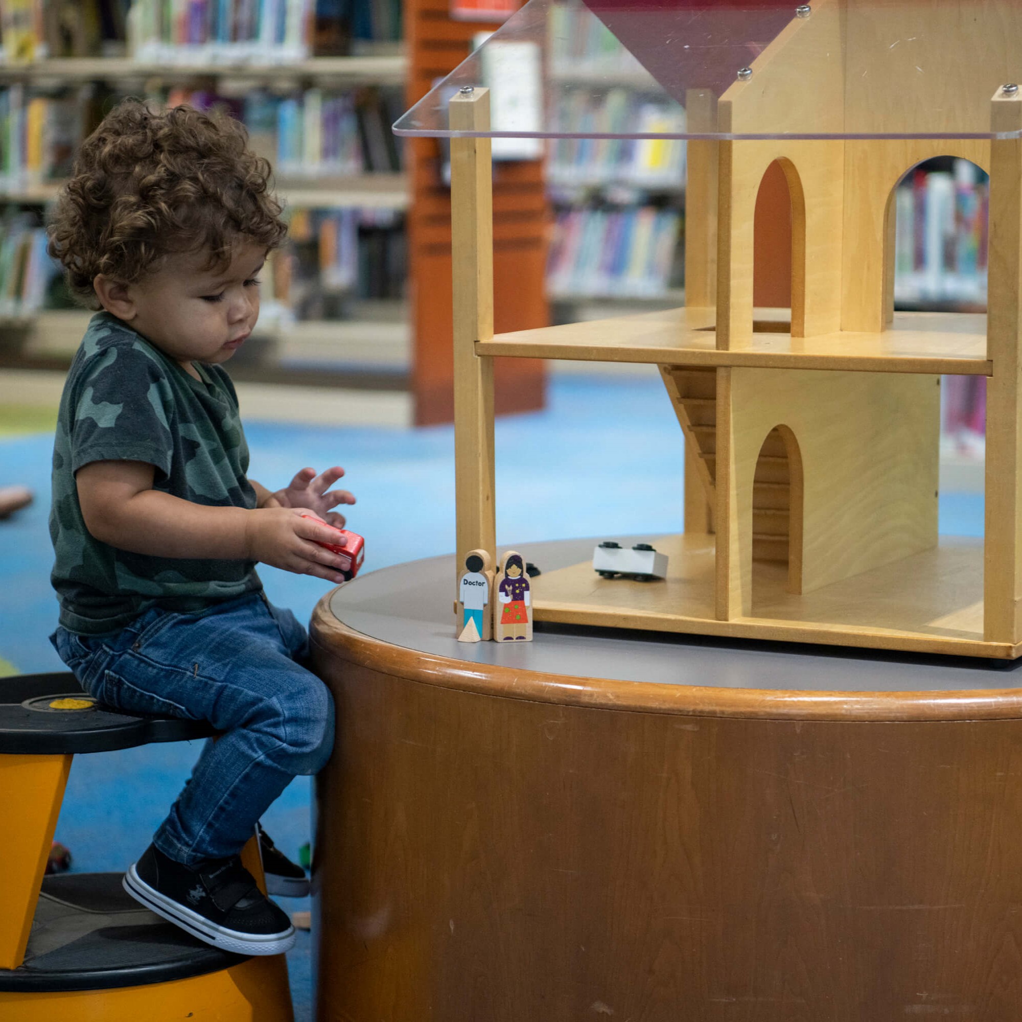 a small child playing with a pretend house